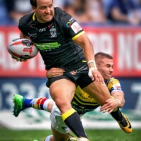 Photo Terry Donnelly - Rugby player being tackled by his opponent